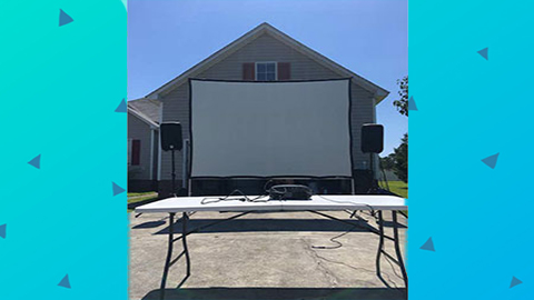 Transform your next gathering with the Movie-Screen-Projector-Rental from Funtime Inflatables NC—featuring a large outdoor projector screen, two quality speakers set up in front of your house, and a folding table for electronic equipment on the driveway. Choose Hammer Strike Funtime Inflatables Rentals NC for top-notch movie projector & screen rental in Wilmington, NC. Bounce house rentals Wilmington NC - Funtime Inflatables NC