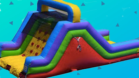 The Rock Climb Rental is a colorful inflatable obstacle course that features a rock-climbing wall and slide, all set against a blue background with playful small triangle graphics. Bounce house rentals Wilmington NC - Funtime Inflatables NC